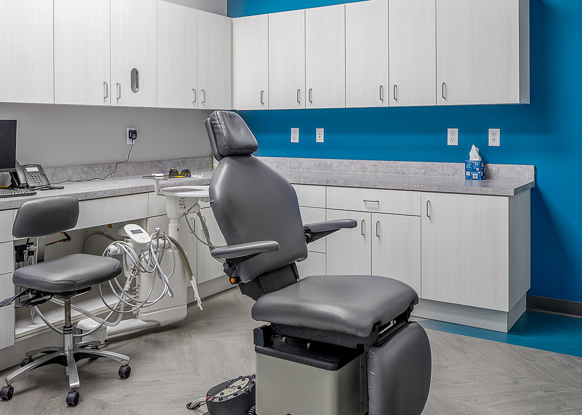 Skyline Pediatric Dentistry exam room with blue wall and light cabinets surrounding