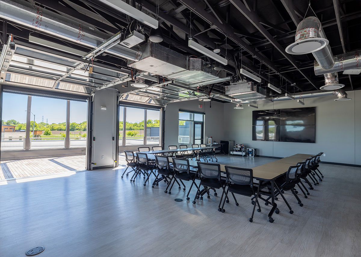 Setpoint Mechanical large conference area with multiple tv screens and large U shaped table set up