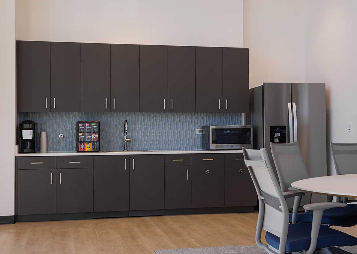 Comparison Insurance kitchenette area with cabinets