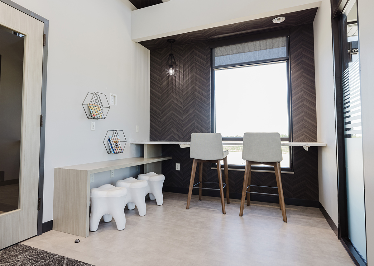 Edwards Smith Family Dentistry waiting area with tooth chairs and stools