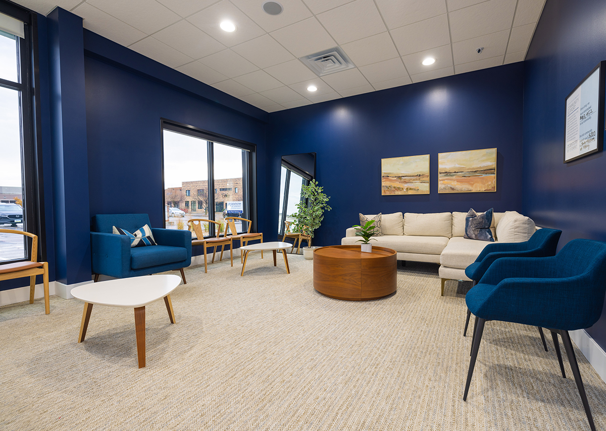 Dentistry at Somerset inside waiting room with blue walls and chairs