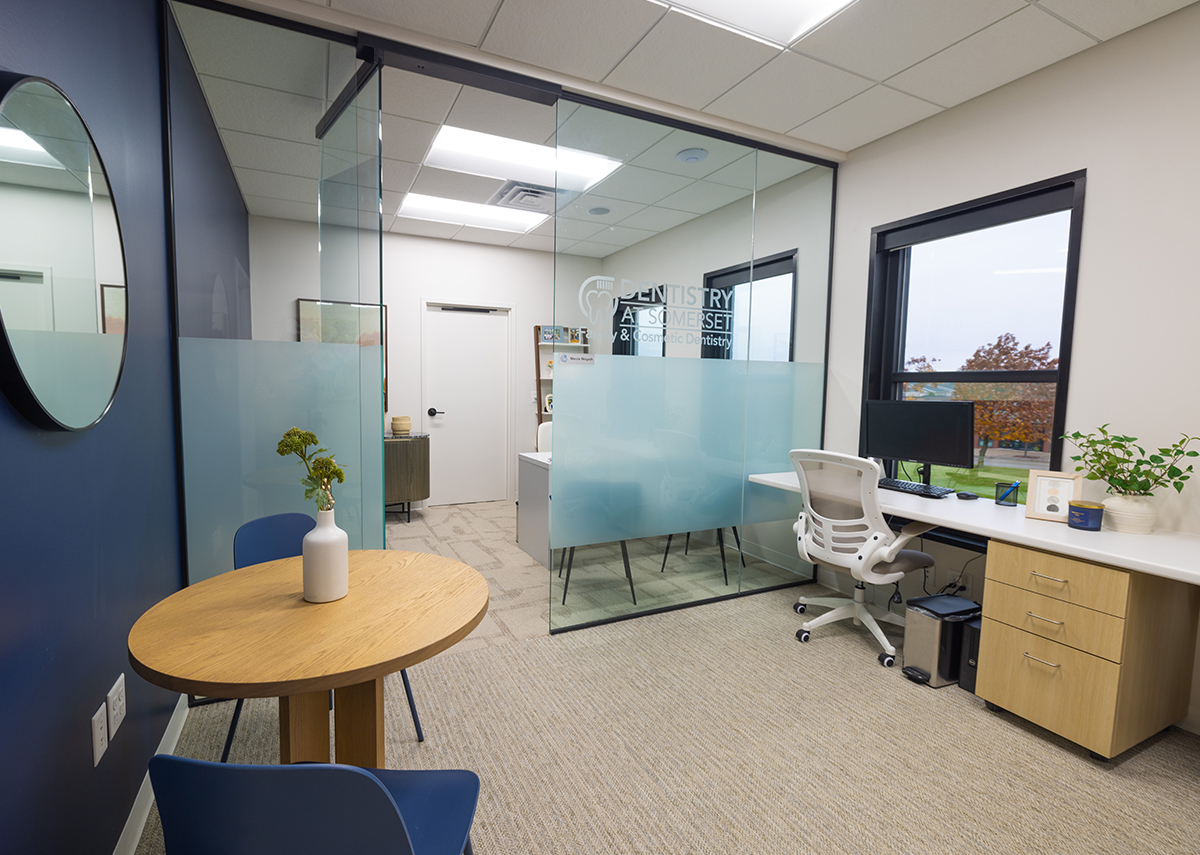 Dentistry at Somerset inside office area with desk, table and glass office area