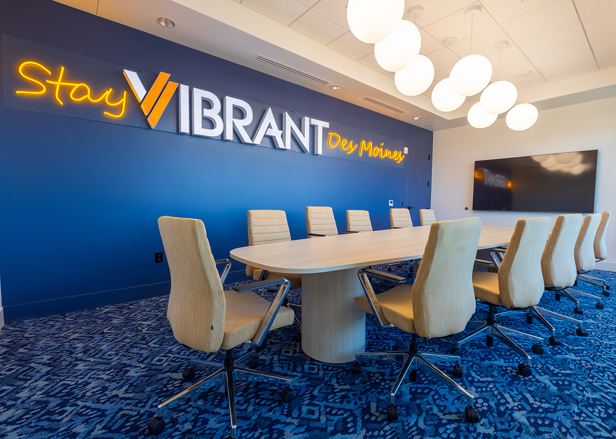Vibrant Insurance meeting room with Stay Vibrant Des Moines sign on blue wall