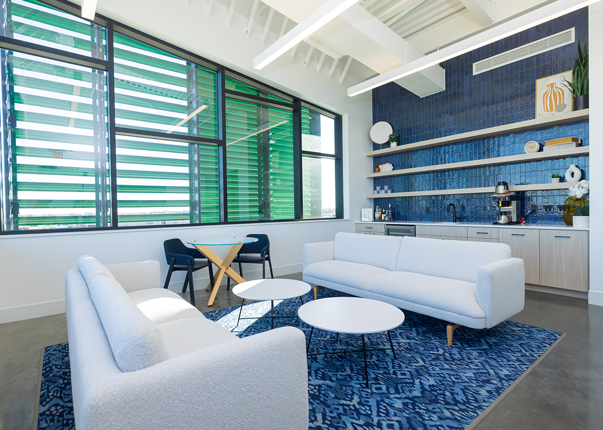 Vibrant Insurance waiting area with couches and little kitchenette in backgrounds