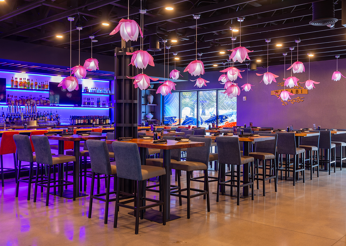 Wasabi bar area with empty high top tables and bar in background